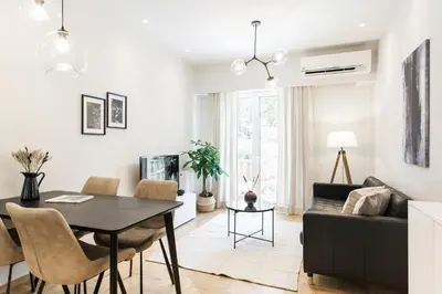 a living room with a table and a couch at Peaceful 2BD Apartment in Kolonaki by UPSTREET in Athens