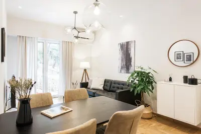 a living room with a table and a couch at Peaceful 2BD Apartment in Kolonaki by UPSTREET in Athens