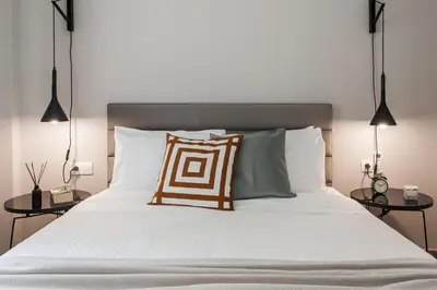 a bed with two pillows on top of it at Peaceful 2BD Apartment in Kolonaki by UPSTREET in Athens
