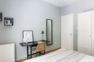 a bedroom with a desk with a mirror and a chair at Peaceful 2BD Apartment in Kolonaki by UPSTREET in Athens
