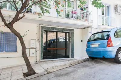 a blue car parked in front of a building at Peaceful 2BD Apartment in Kolonaki by UPSTREET in Athens