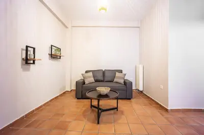 a living room with a couch and a table at GK Niki by GK Properties in Athens