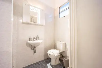 a bathroom with a toilet and a sink at GK Niki by GK Properties in Athens