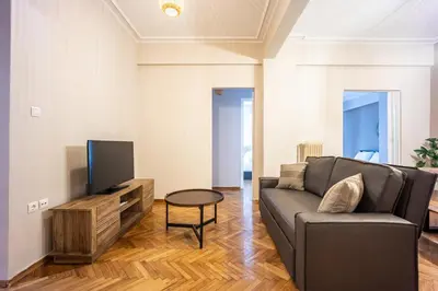 a living room with a couch and a tv at GK Niki by GK Properties in Athens