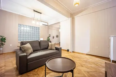 a living room with a couch and a table at GK Niki by GK Properties in Athens