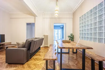 a living room with a table and a chair at GK Niki by GK Properties in Athens