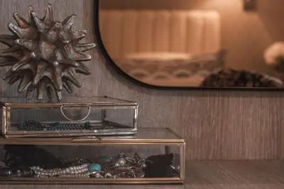 a glass box on a table in front of a mirror at Sea view super romantic apartment in Athens
