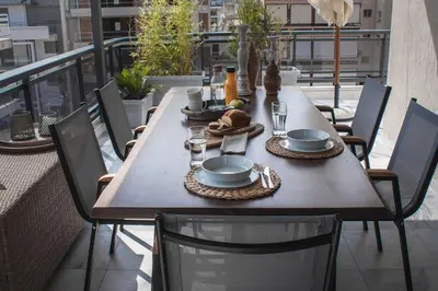 a wooden table with plates of food on a balcony at Sea view super romantic apartment in Athens