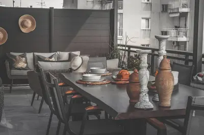 a table with bowls and vases on a balcony at Sea view super romantic apartment in Athens