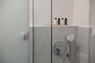 a shower with a glass door in a bathroom at The Convo Athens Riviera in Athens