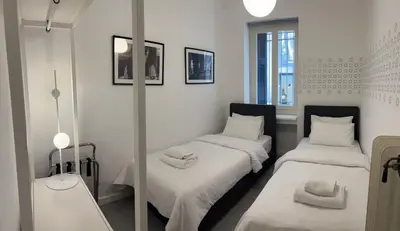 a room with two beds and a mirror at Art in Athens Suite in Athens