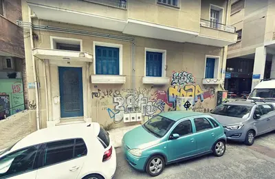 three cars parked in front of a building with graffiti at Art in Athens Suite in Athens