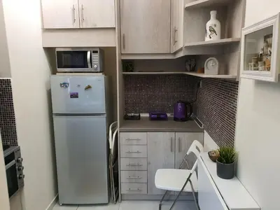 a small kitchen with a refrigerator and a microwave at Cozy Little Home in Athens