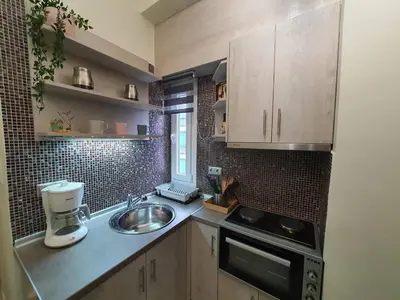 a small kitchen with a sink and a microwave at Cozy Little Home in Athens