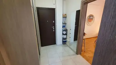 a hallway with a black door and a mirror at Cozy Little Home in Athens