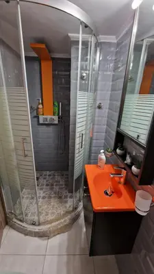 a bathroom with an orange sink and a shower at Cozy Little Home in Athens