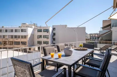 a table on a balcony with two glasses of orange juice at Athens Terrace 360° in Athens