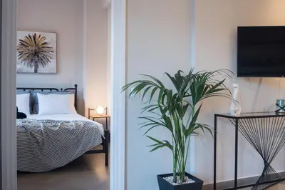 a bedroom with a bed and a potted plant at Athens Terrace 360° in Athens