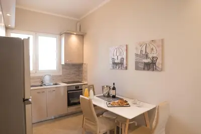 a kitchen with a table and chairs in a kitchen at Athens Terrace 360° in Athens