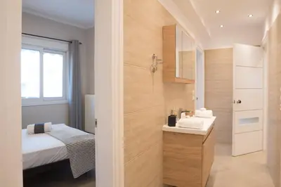 a small bathroom with a sink and a bed at Athens Terrace 360° in Athens