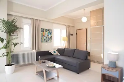 a living room with a couch and a table at Athens Terrace 360° in Athens