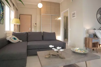 a living room with a couch and a table at Athens Terrace 360° in Athens