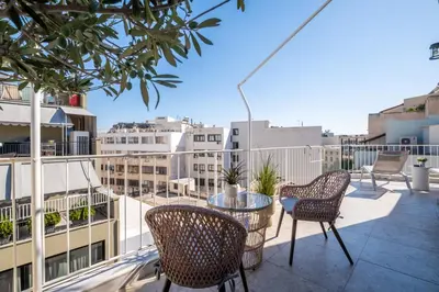 a balcony with chairs and a table on a building at Athens Terrace 360° in Athens