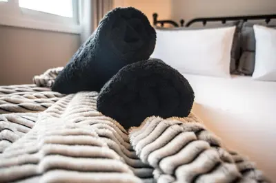 a blanket with two stuffed animals on a bed at Athens Terrace 360° in Athens