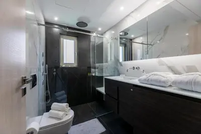a bathroom with a shower and a toilet and a sink at Olygreen Athens Residences in Athens