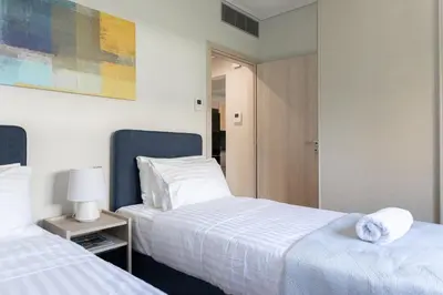 a hotel room with two beds and a mirror at Olygreen Athens Residences in Athens