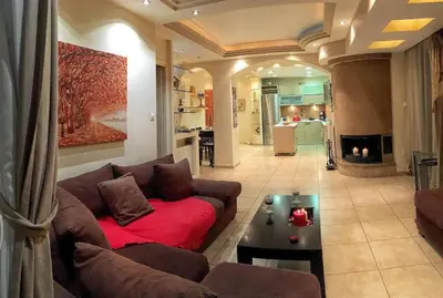 a living room with a couch and a table at A1 Elegant Vouliagmeni apt in a Unique Spot in Athens