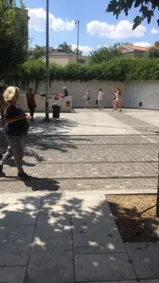 a group of people walking on a sidewalk at Check Point - Acropolis in Athens