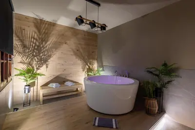 a large bathroom with a tub and potted plants at NOHO Boutique , premium living Dikeou 8 in Athens