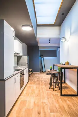 a large kitchen with a table and a dining room at NOHO Boutique , premium living Dikeou 8 in Athens