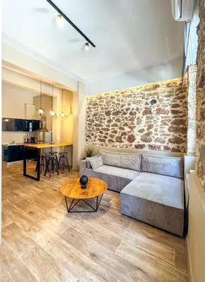 a living room with a couch and a table at NOHO Boutique , premium living Dikeou 8 in Athens