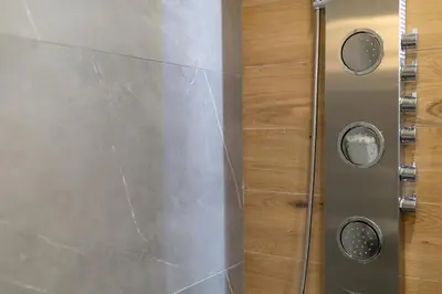 a shower in a bathroom with a metal wall at NOHO Boutique , premium living Dikeou 8 in Athens