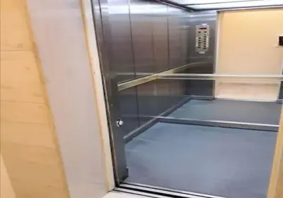 an empty elevator with a glass door in a room at House in the center of Piraeus next to the port and the metro!! in Piraeus
