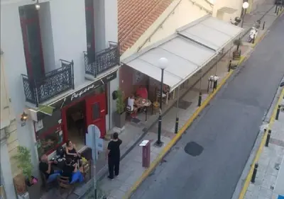 an overhead view of a store with people standing outside at House in the center of Piraeus next to the port and the metro!! in Piraeus