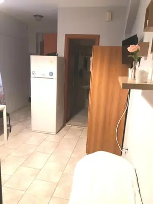 a kitchen with a white refrigerator and a tile floor at House in the center of Piraeus next to the port and the metro!! in Piraeus