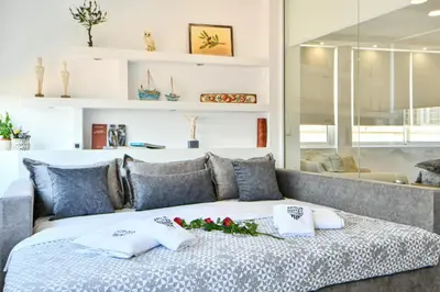 a bedroom with a bed with towels on it at AEOLIS SUITES in Athens