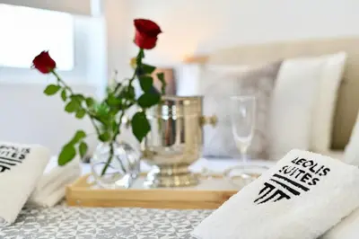 a table with a vase with a rose in a vase at AEOLIS SUITES in Athens