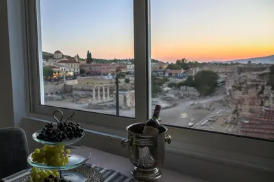 a table with a view of a city from a window at AEOLIS SUITES in Athens