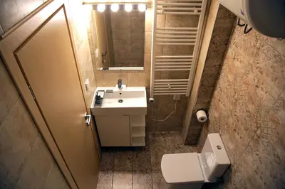 a bathroom with a sink and a toilet and a mirror at Your Attiki Home VIPGreece in Athens