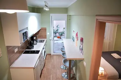 a small kitchen with a counter and a bed at Your Attiki Home VIPGreece in Athens