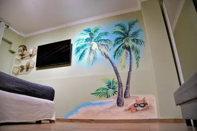 a mural of palm trees and a cat on a wall at Your Attiki Home VIPGreece in Athens