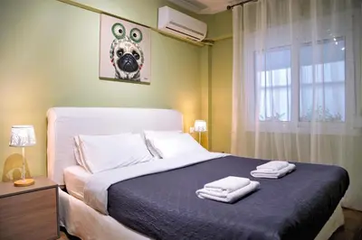a bedroom with a bed with two towels on it at Your Attiki Home VIPGreece in Athens