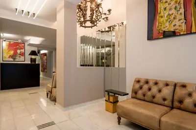 a living room with a couch and a chandelier at Fos DownTown Suites in Athens