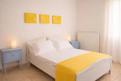 a bedroom with a bed with two night stands and two lamps at Apartment in Peania (15min from Airport) in Paianía