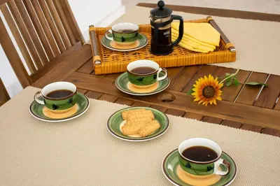 a table with three cups of coffee and biscuits on plates at Apartment in Peania (15min from Airport) in Paianía