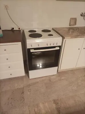 a kitchen with a stove and a counter top at Stamatis Big Apartment in Spáta